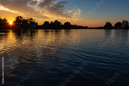 Beautiful sun rays during sunset in lake Zoetermeerse plas