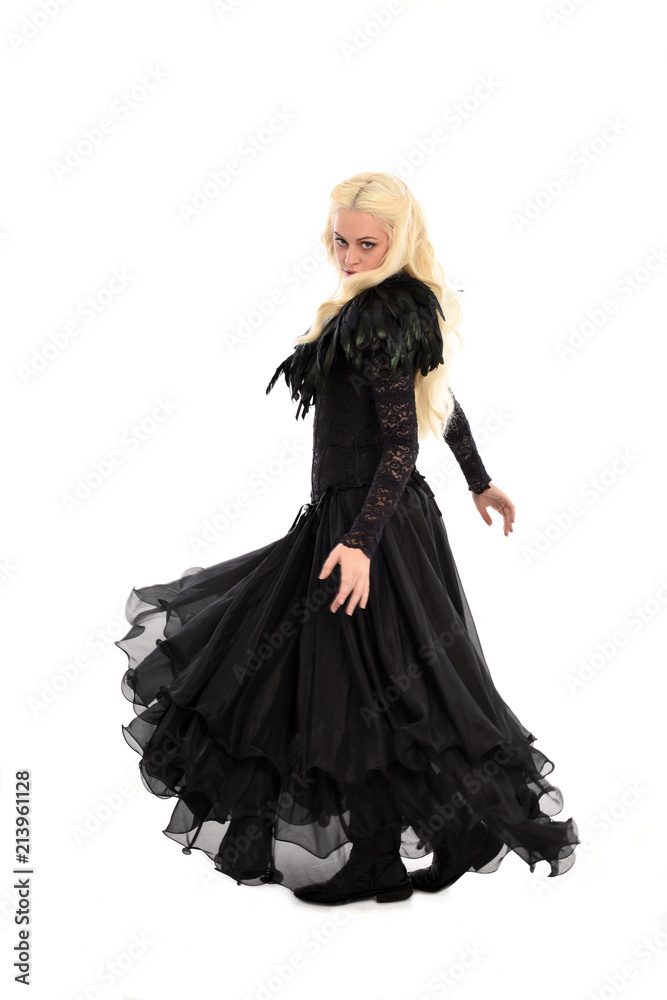 full length portrait of blonde girl wearing corset and long black gown. isolated on white studio background, full length portrait of blonde girl wearing corset and long black gown. isolated on white studio background,