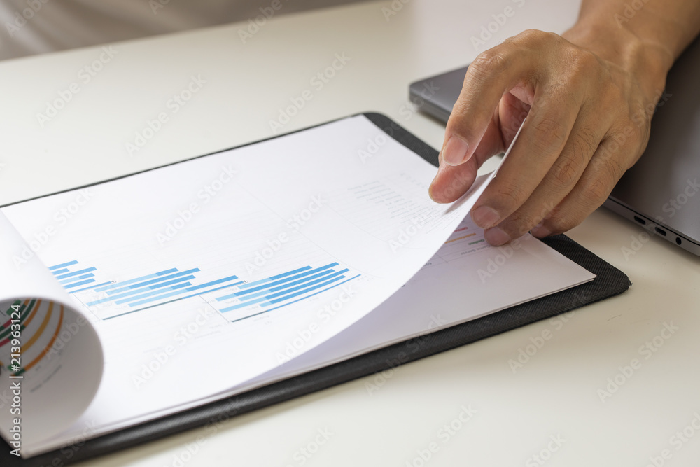 Business person analyzing financial on paperwork Business person analyzing financial on paperwork