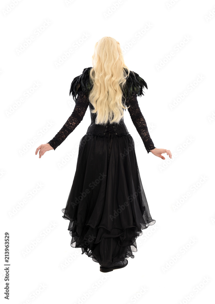 full length portrait of blonde girl wearing corset and long black gown. isolated on white studio background, full length portrait of blonde girl wearing corset and long black gown. isolated on white studio background,