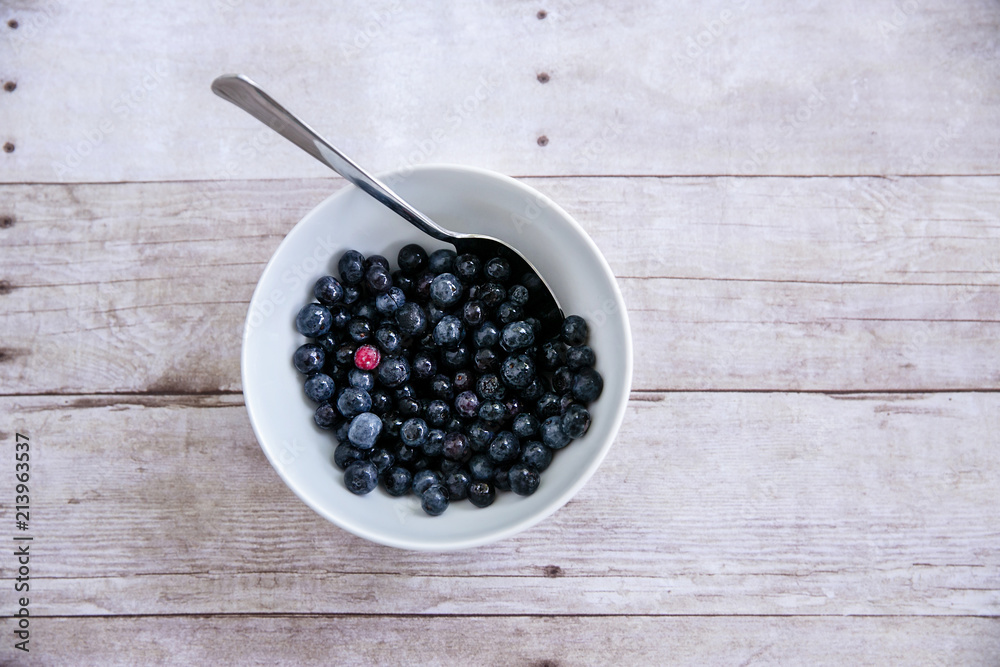 White Bowl with Blueberries and Spoon One Being Different Unique White Bowl with Blueberries and Spoon One Being Different Unique