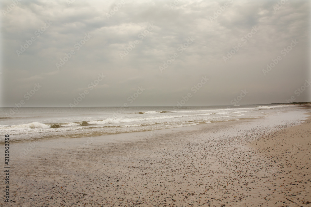 North Sea beach in Denmark at cloudy day. North Sea beach in Denmark at cloudy day.