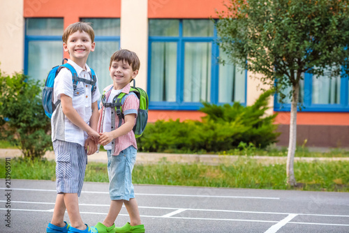Canvas Print Young students, two sibling brothers, going to school.