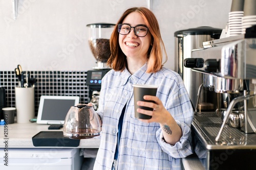 Barista girl serves a Cup of coffee