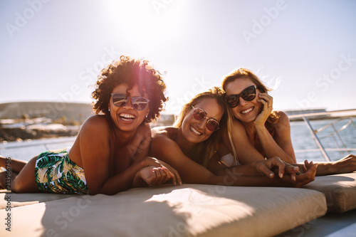 Beautiful female friends relaxing on yacht