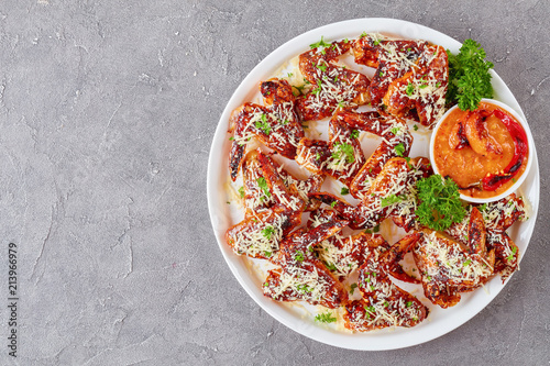 chicken wings sprinkled with grated parmesan