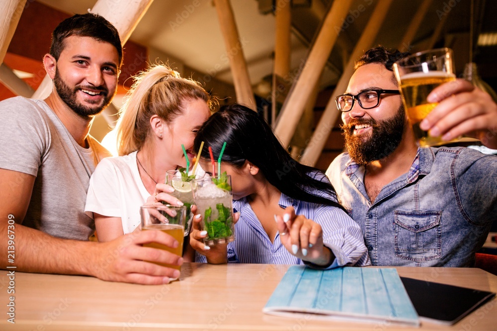 Friends at a party in a night bar drinking alcoholic beverages Friends at a party in a night bar drinking alcoholic beverages