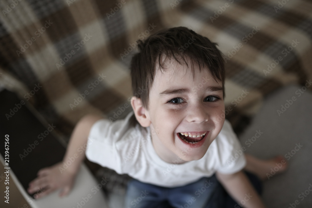 Toddler child happy on couch in real room at home Toddler child happy on couch in real room at home