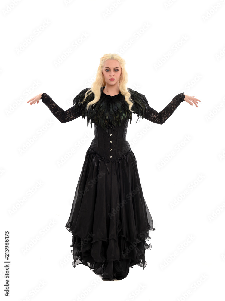 full length portrait of blonde girl wearing corset and long black gown. isolated on white studio background, full length portrait of blonde girl wearing corset and long black gown. isolated on white studio background,