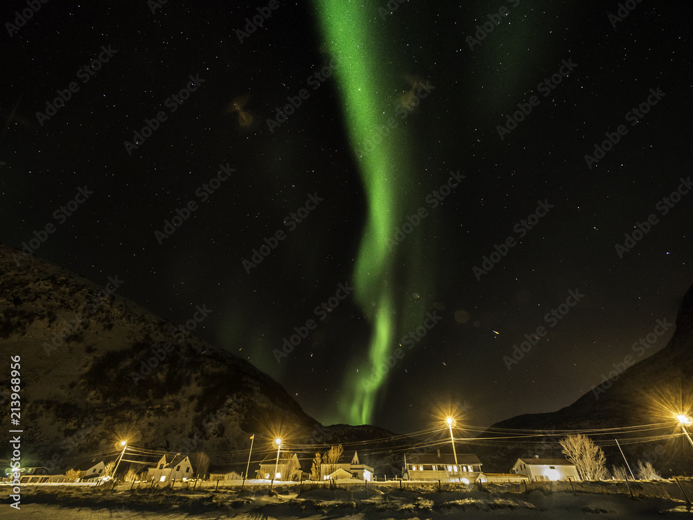 Northern light dancing across starry sky in Norway