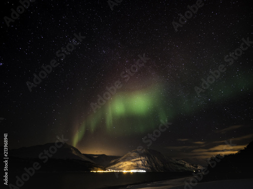 Obraz na płótnie Northern light dancing across starry sky in Norway w salonie