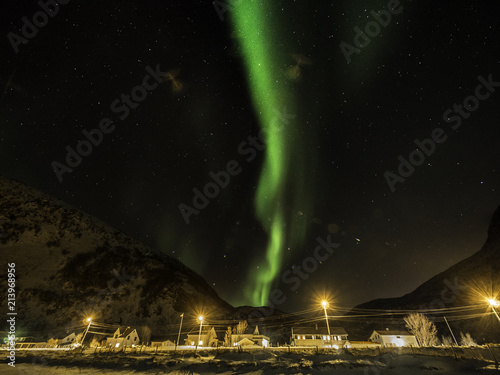 Northern light dancing across starry sky in Norway