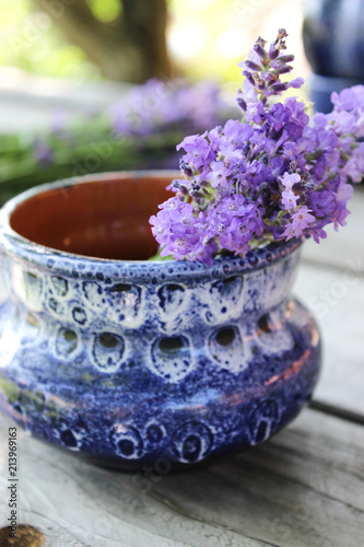 Fototapeta Naklejka Na Ścianę i Meble -  A bouquet of fresh cut lavender with tableware Gzhel