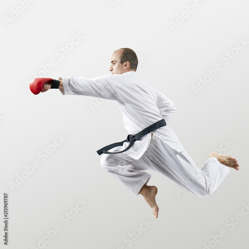 With red overlays on the hands adult athlete beats with a hand in the jump