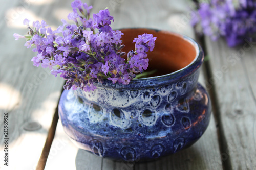 Fototapeta Naklejka Na Ścianę i Meble -  A bouquet of fresh cut lavender with tableware Gzhel