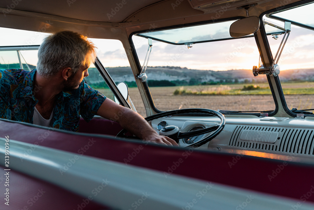 Man leaning on steering wheel of car Stock Photo Adobe Stock