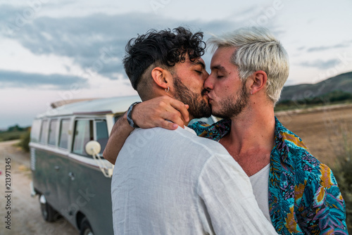 Gay couple kissing in nature photo