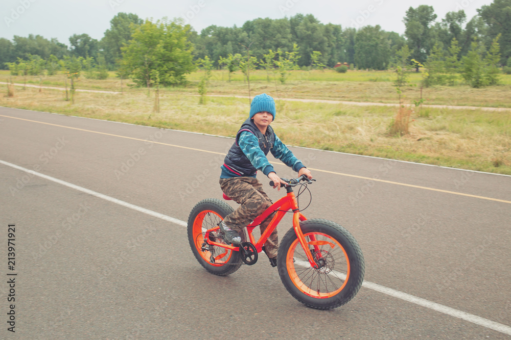 young boy riding a bike