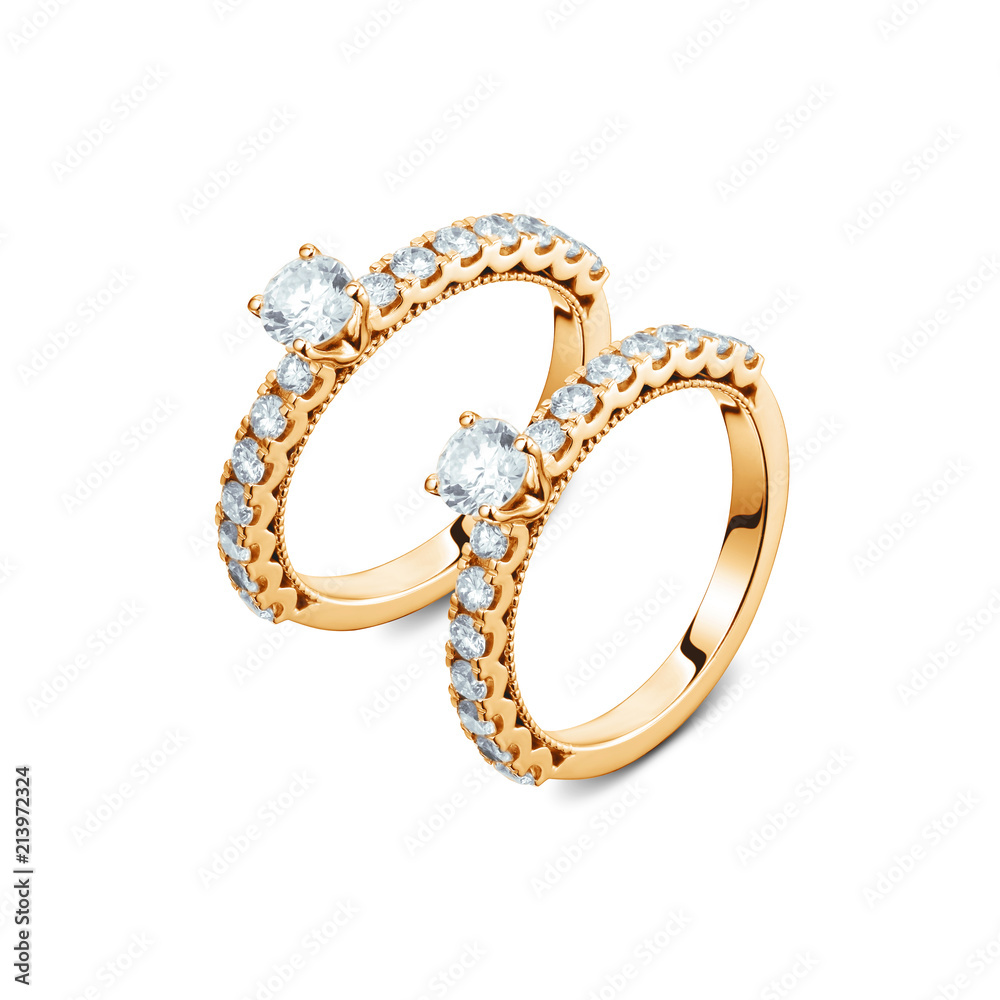A pair of luxury yellow gold rings with diamonds on the white background, A pair of golden rings isolated A pair of luxury yellow gold rings with diamonds on the white background, A pair of golden rings isolated