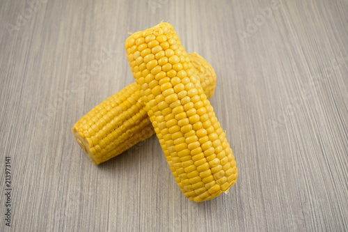 Corn on the cob stock images. Corn on a wooden background. Yellow
maize stock images. Two corn cobs photo