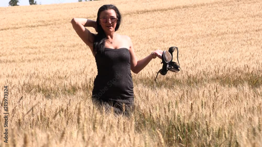 The brunette walks the wheat field,slow motion The brunette walks the wheat field,slow motion