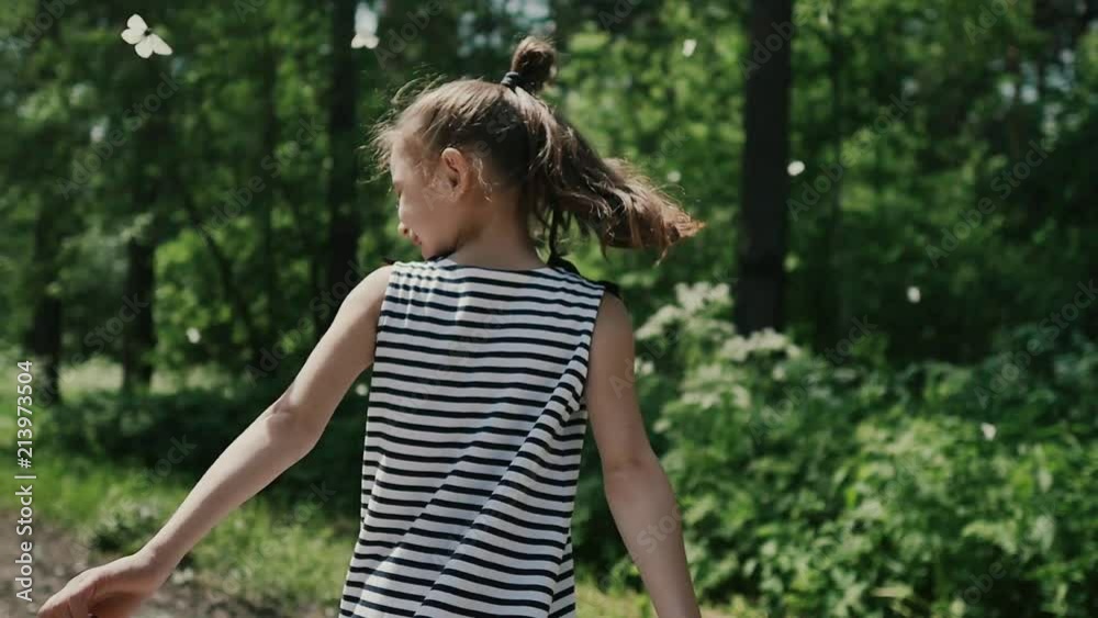Young girl in nature holding a rice paper butterfly Young girl in nature holding a rice paper butterfly