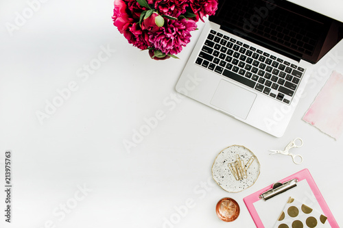 Fototapeta Naklejka Na Ścianę i Meble -  Flat lay office table desk with laptop, peony flower bouquet. Top view work concept background.
