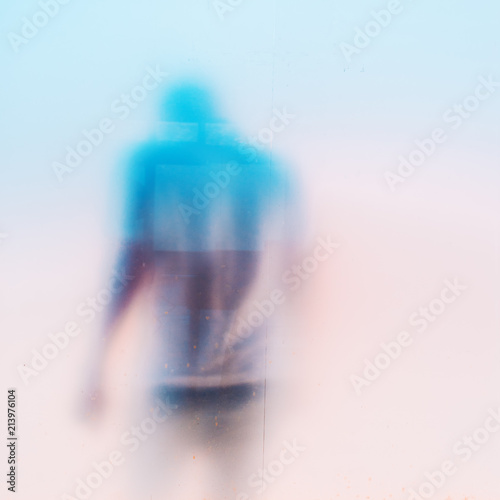 Quadro su tela Silhouette of sad depressed masculine man behind dirty glass