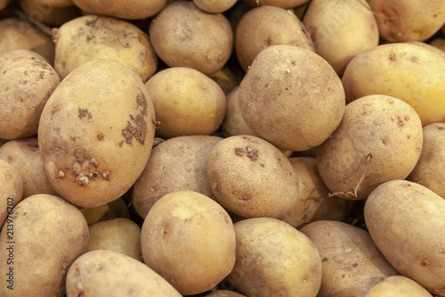 Pile of fresh organic potatoes top view close up.