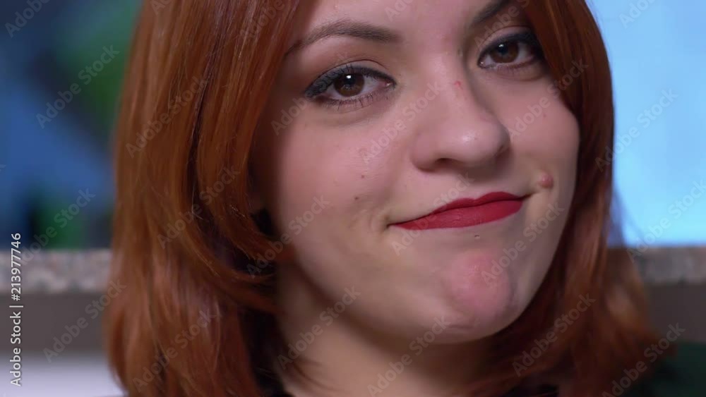 Attractive sexy red hair woman smiling at camera- slow motion- close up Attractive sexy red hair woman smiling at camera- slow motion- close up