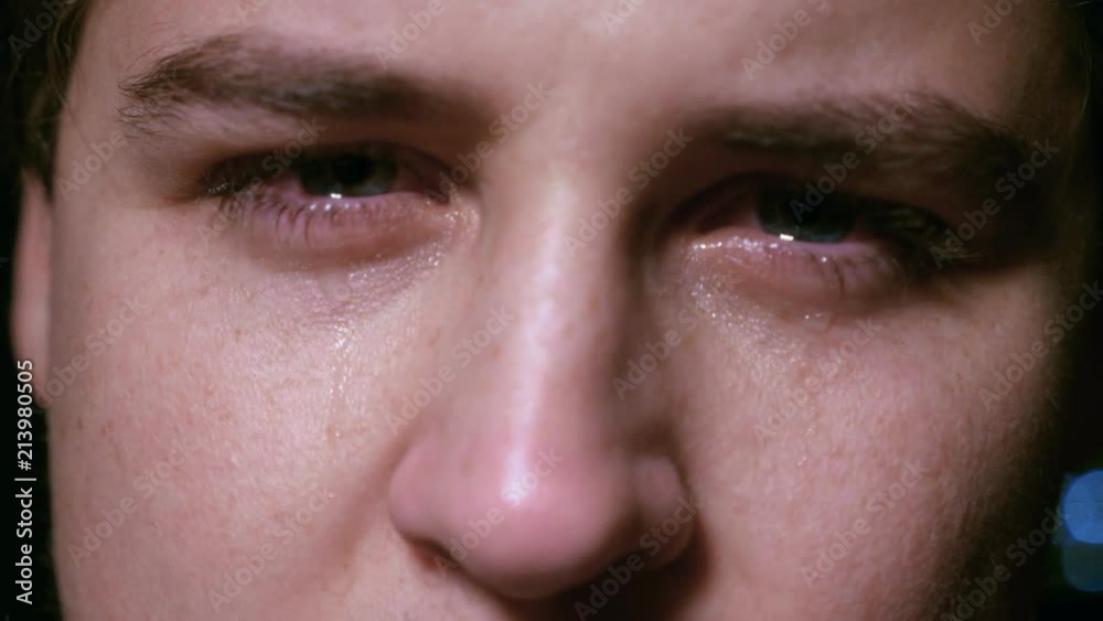 depressed young man crying - macro depressed young man crying - macro