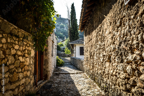 A narrow stone pathway in the medieval city of Pocitelj Capljina in Bosnia and Herzegovina photo