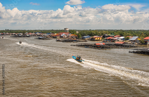 Fisherman villages along Kurau river at Kuala Kurau bridge in Malaysia. photo