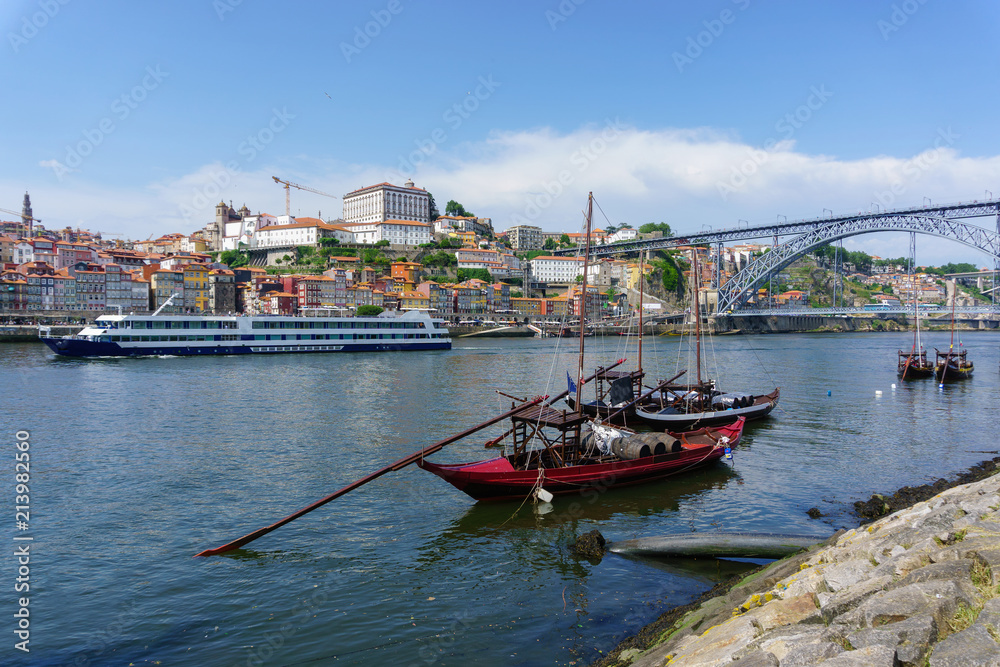 Typical boats of the Douro River in Oporto. Panoramic views of the historic city center of Porto in Portugal. Landscape at famous travel destination.