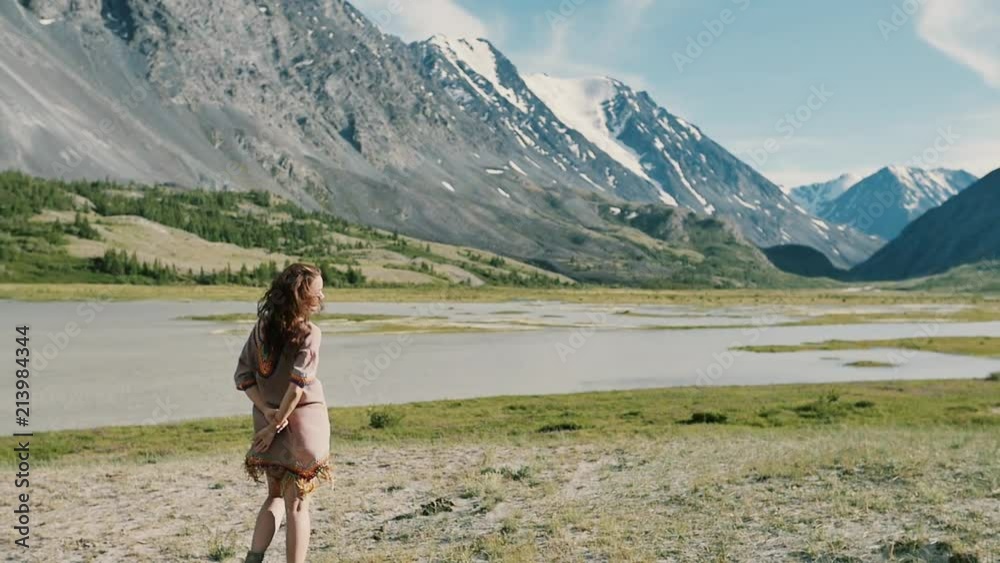 Woman on top of mountain. Girl lifting arm up celebrating scenic nature landscape enjoying vacation travel adventure Woman on top of mountain. Girl lifting arm up celebrating scenic nature landscape enjoying vacation travel adventure