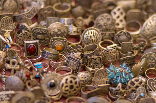 Εκτύπωση καμβά Many old rings made out of silver lying on red cloth ready for sale