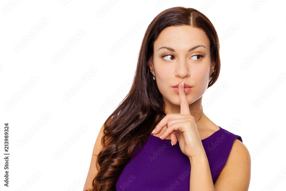 Young beautiful woman has put forefinger to lips as sign of silence Young beautiful woman has put forefinger to lips as sign of silence