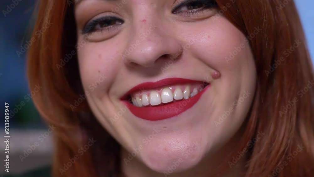 Attractive sensual red hair young woman smiling at camera- slow motion Attractive sensual red hair young woman smiling at camera- slow motion