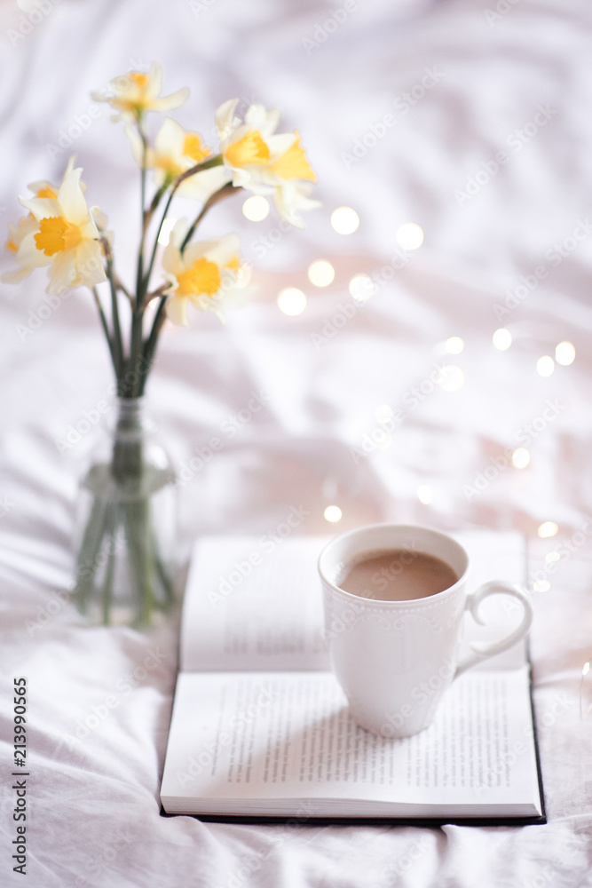 Good morning with fresh cup of coffee and reading in bed. 
