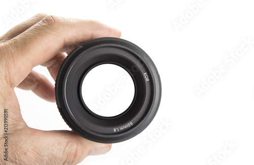 Hand holding camera lens on the white with the sign focus on photo