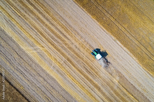 Aerial drone view of tractor plowing field