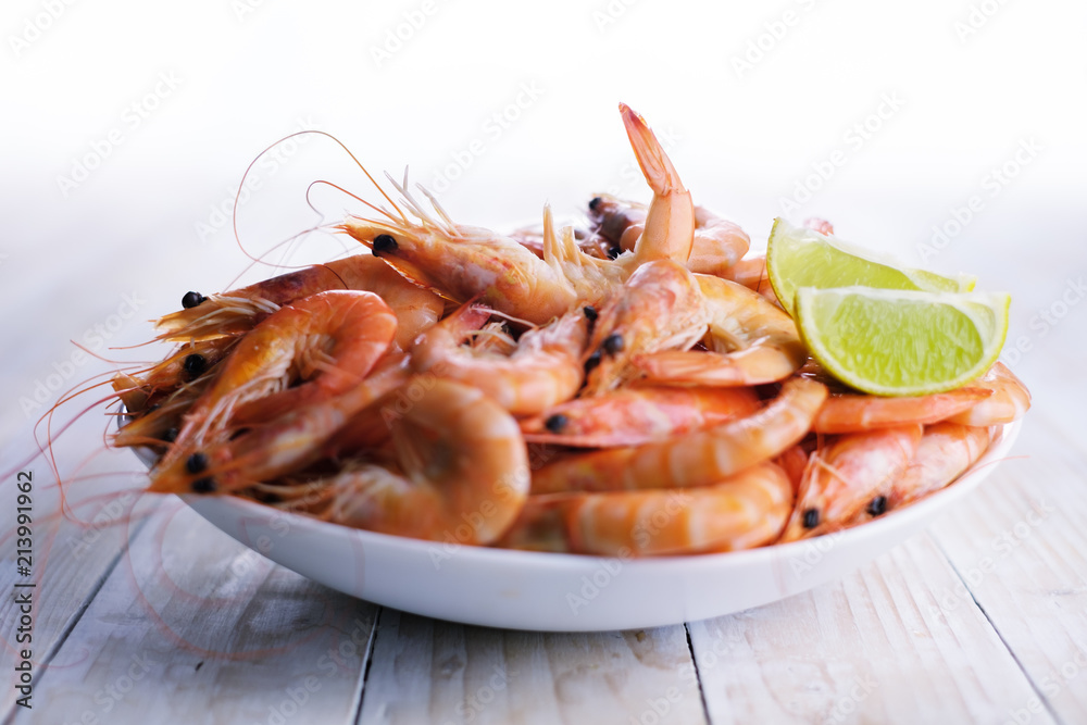 Big boiled shrimps in white plate close up. Seafood concept. Food photography Big boiled shrimps in white plate close up. Seafood concept. Food photography