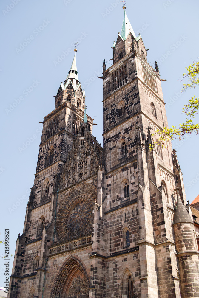 Fototapeta premium Saint Lawrence cathedral on the blue sky background. Medieval gothic church in Nuremberg, Bavaria, Germany