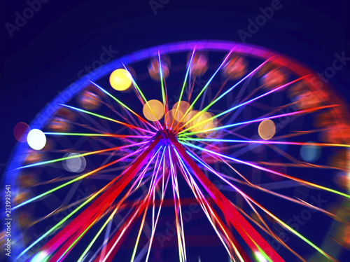Defocused ferris wheel with colorful lights, Blur abstract background ready for your design