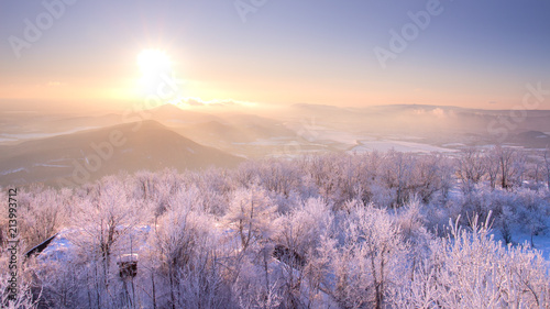 Beautiful winter sunrise lanscape with hills photo