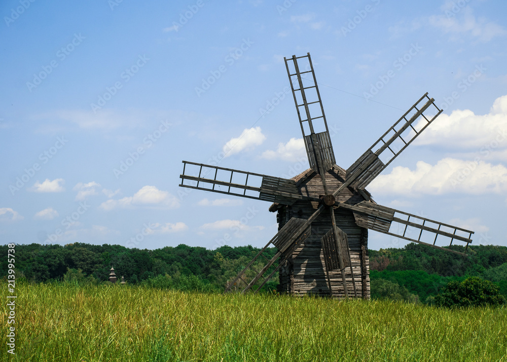 Old wooden windmill in a meadow