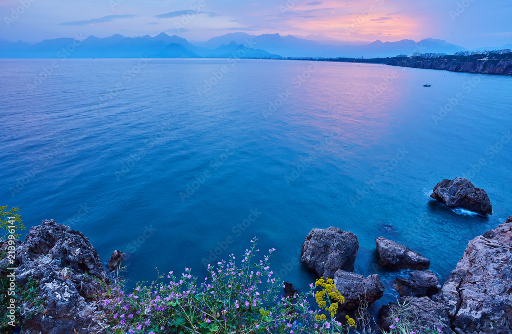 Seascape timelapse of high mountains over clear sunset sky in Antalya, Turkey.