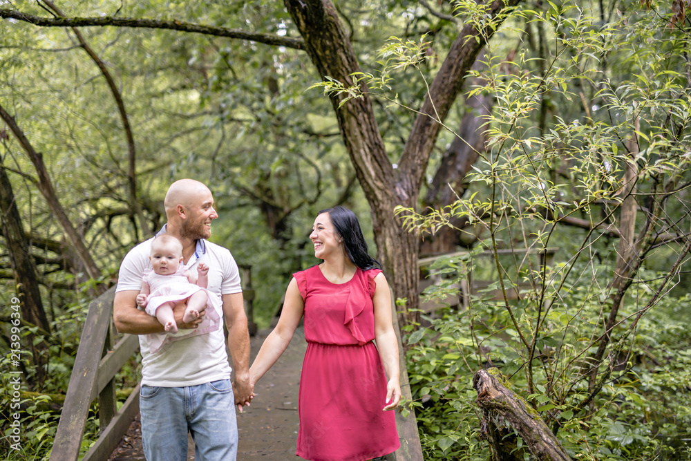 Father Mother and daughter baby in summer meadow park
