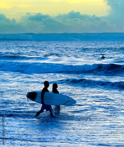 Silhouette of surfers couple