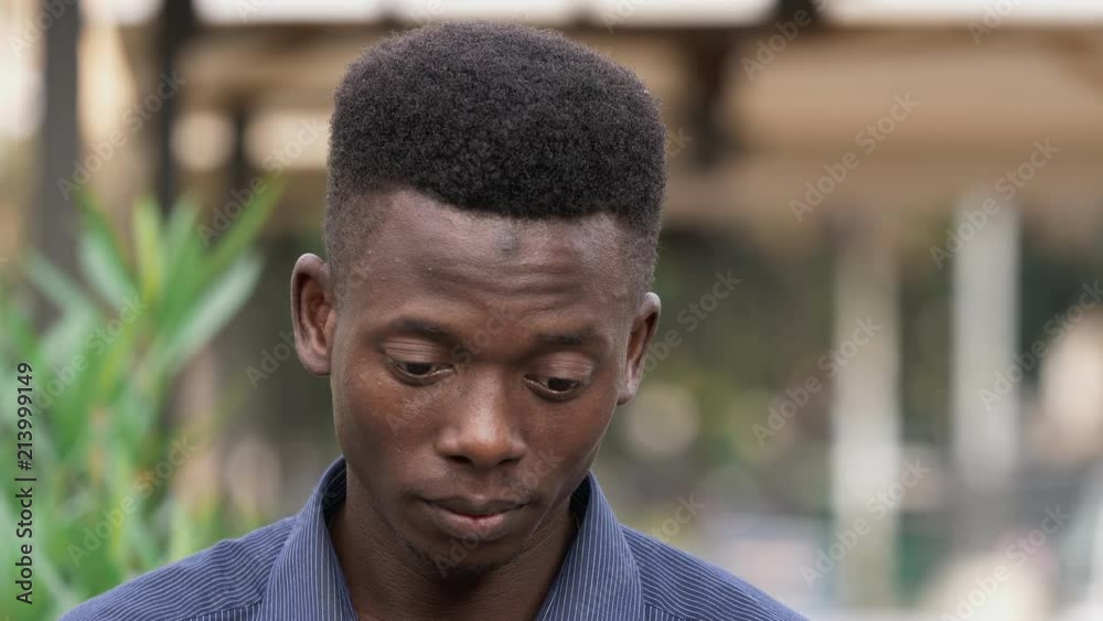 pensive young american african man starts laughing at camera pensive young american african man starts laughing at camera